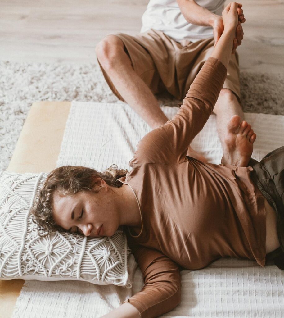 Person lying on the floor appearing physically exhausted and tense in a home environment